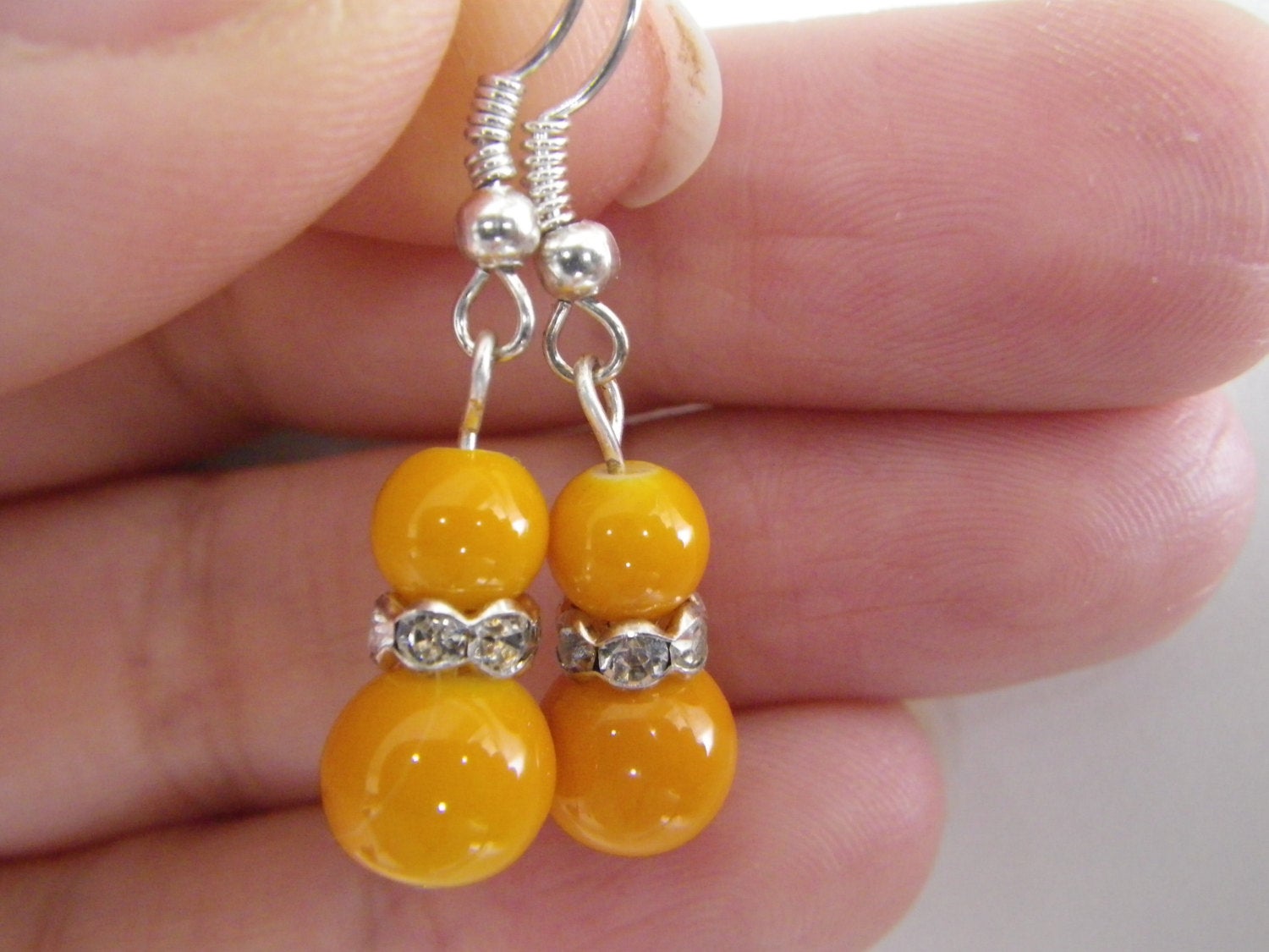 Women’s fashion earrings in Orange beads with rhinestone spacers