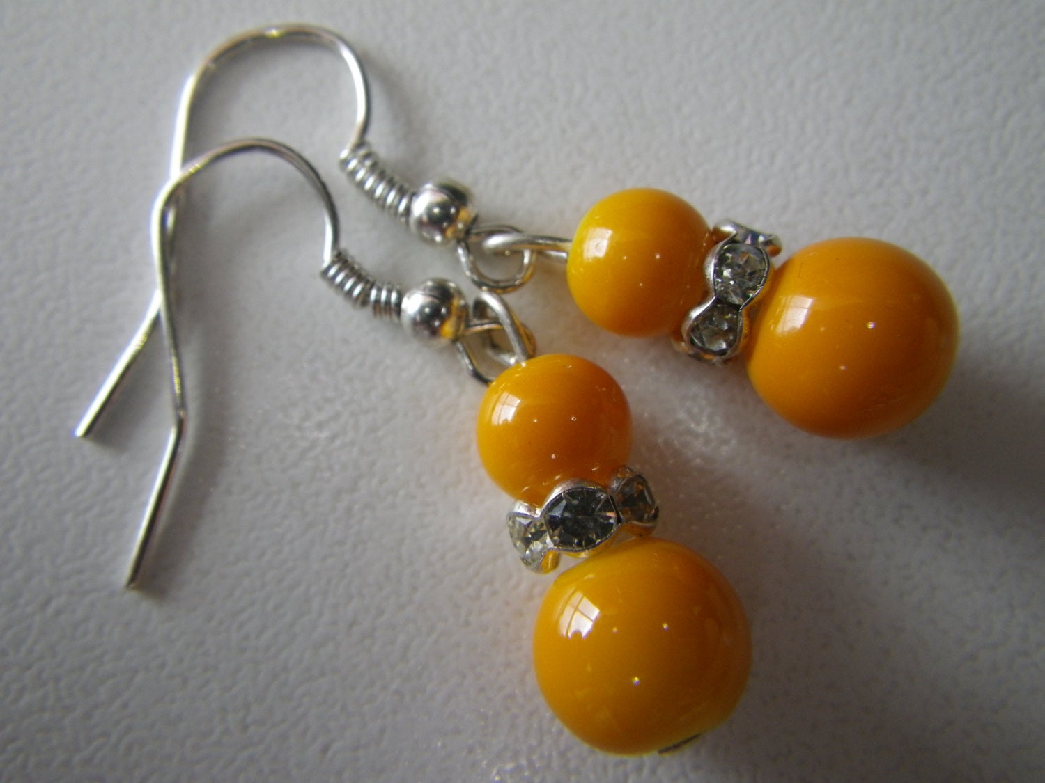 Women’s fashion earrings in Orange beads with rhinestone spacers