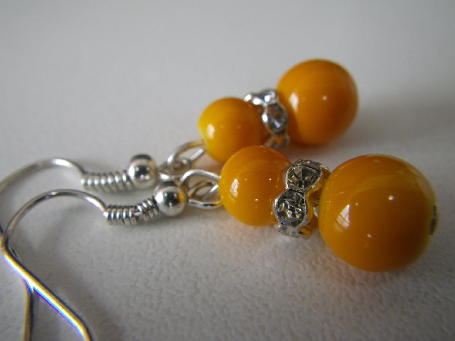 Women’s fashion earrings in Orange beads with rhinestone spacers