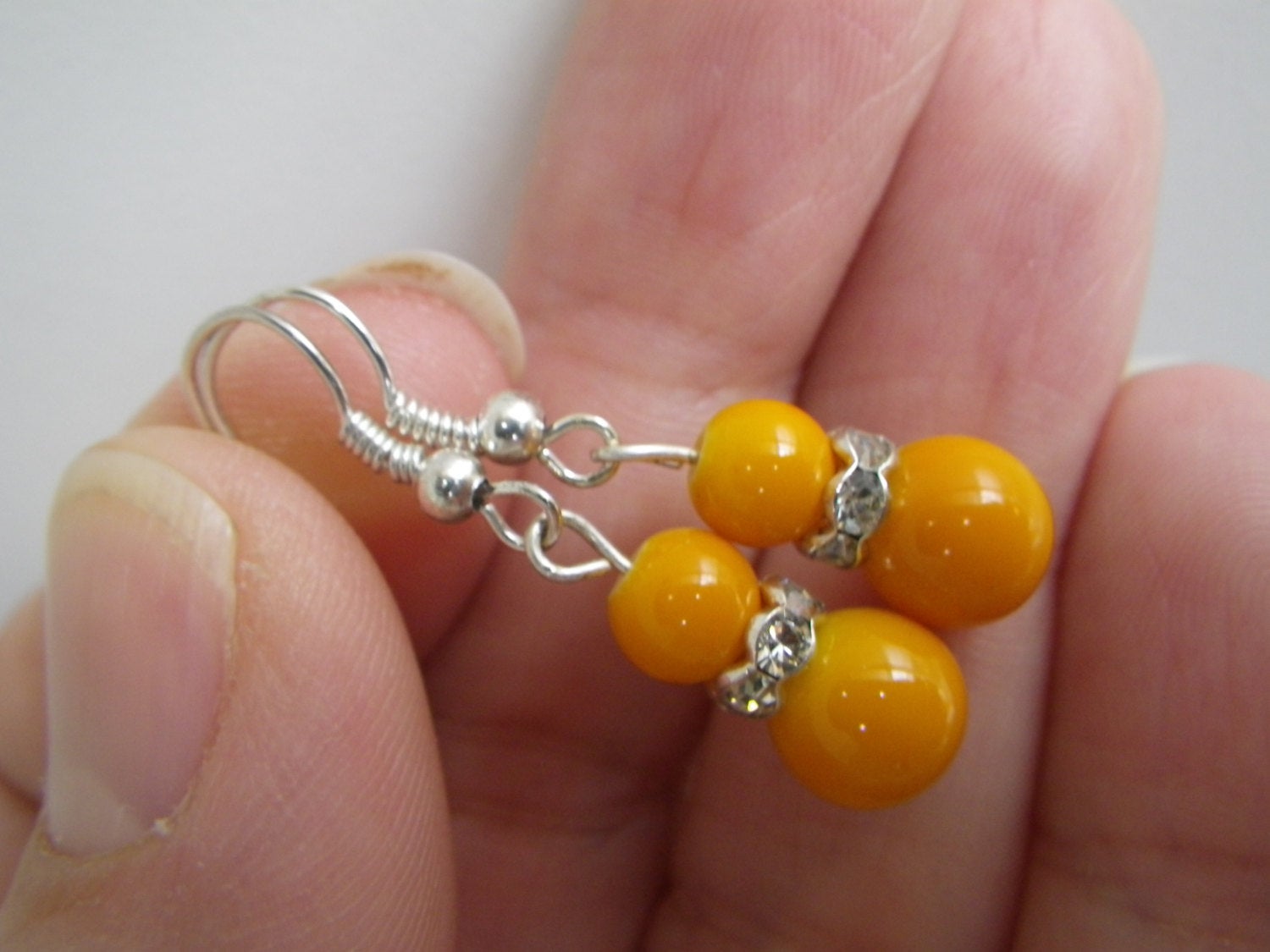 Women’s fashion earrings in Orange beads with rhinestone spacers