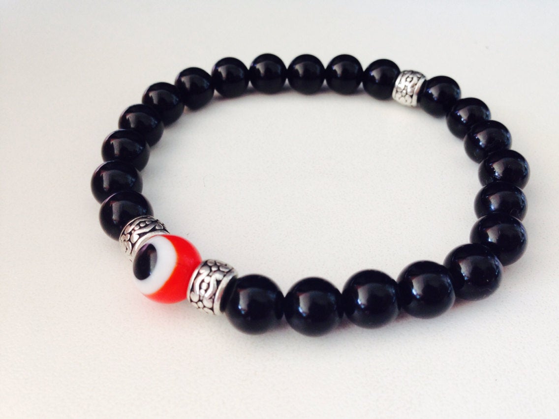 Men's bracelet featuring red evil eye bead and black onyx stone beads